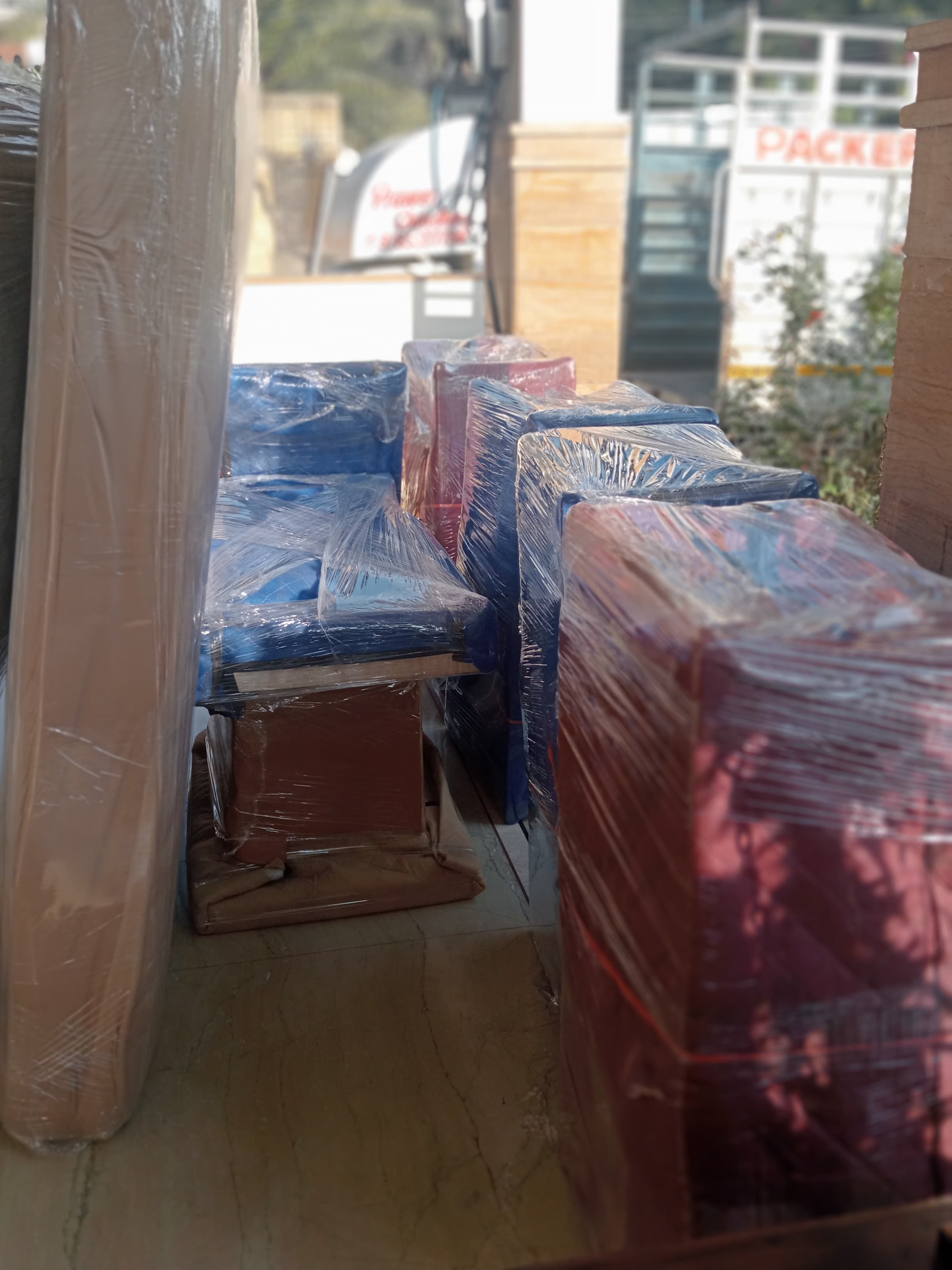 Movers carrying a refrigerator down stairs