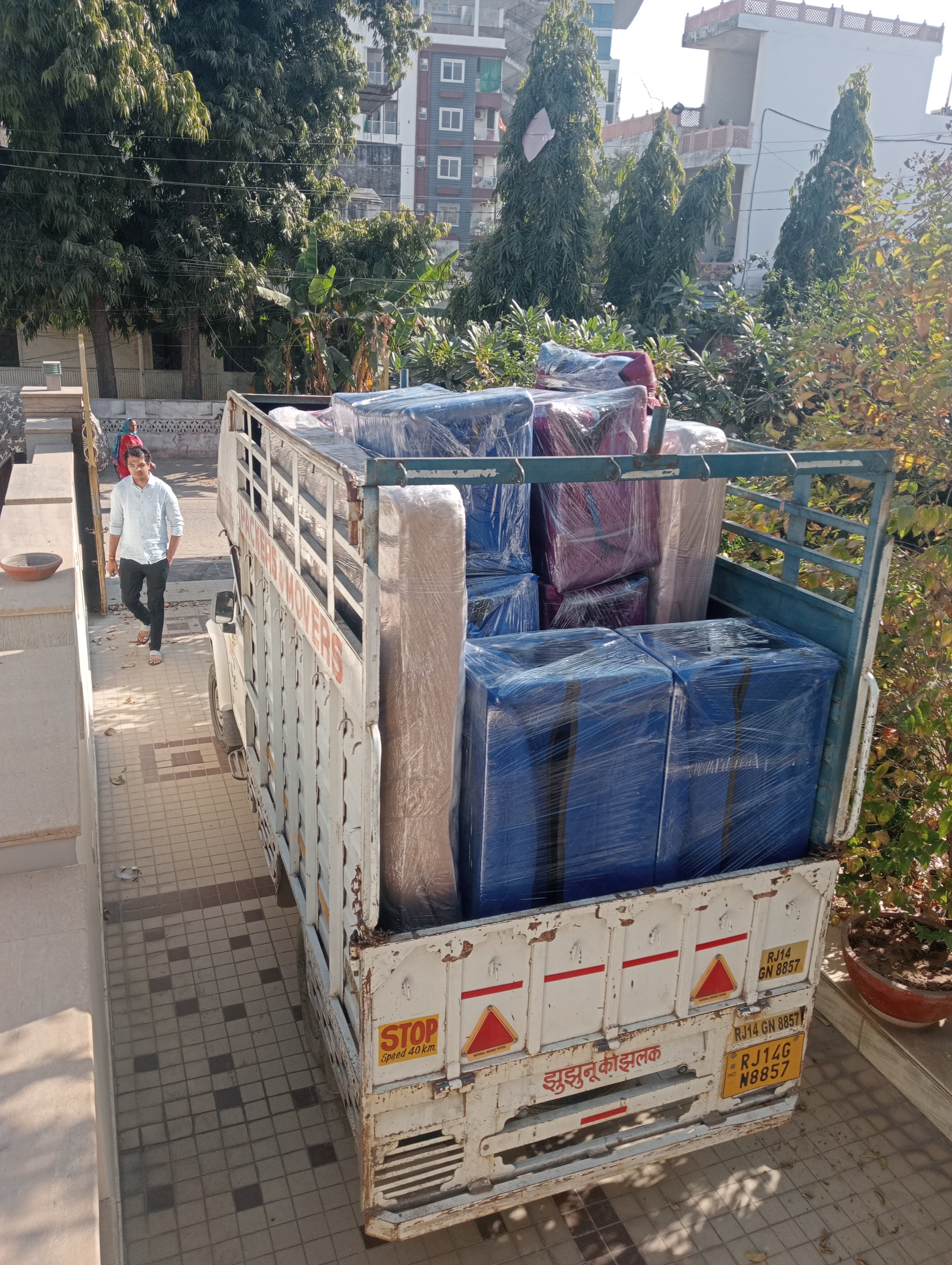 Movers loading a wardrobe into the truck