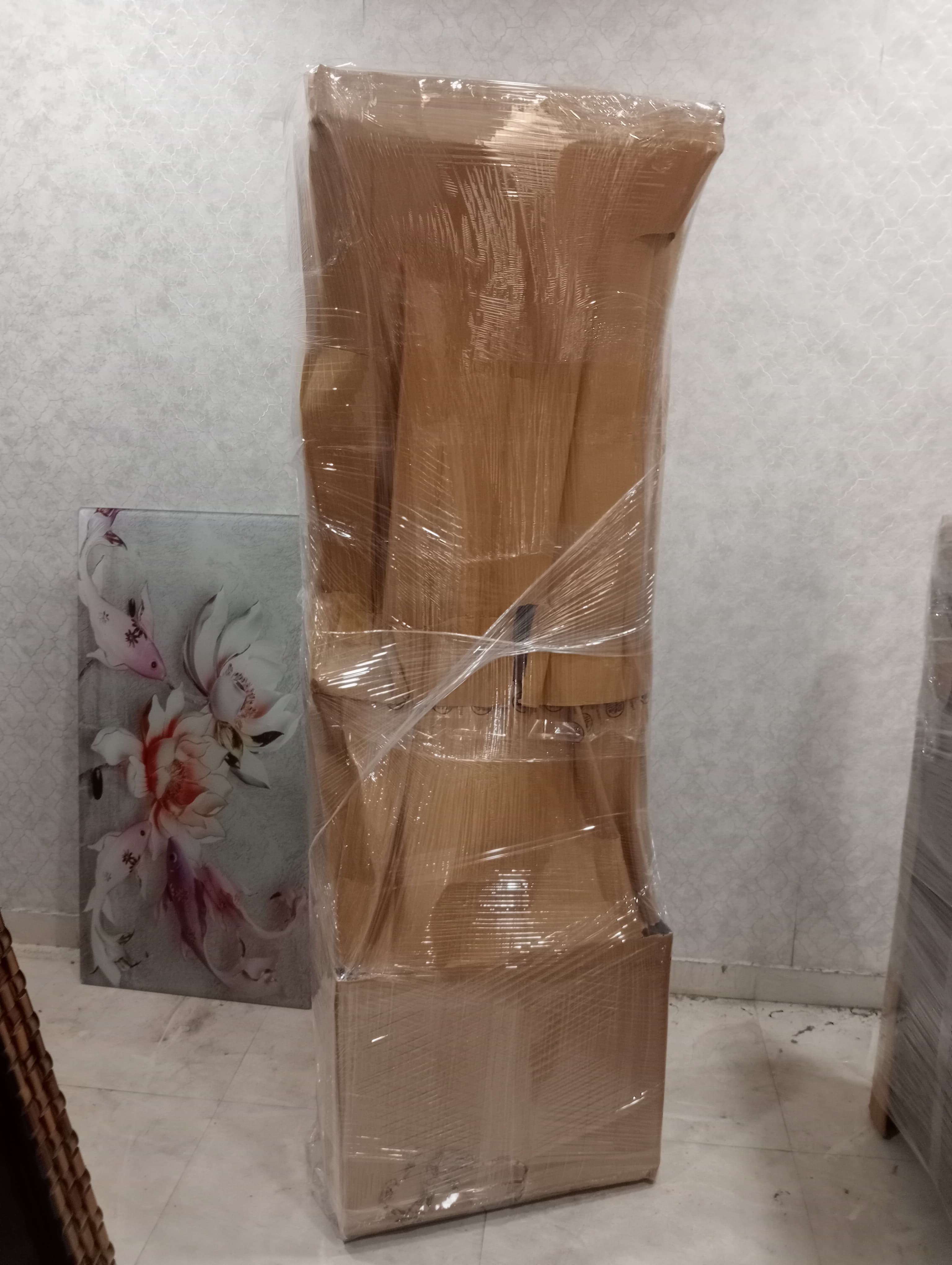 Team using a dolly to move heavy boxes