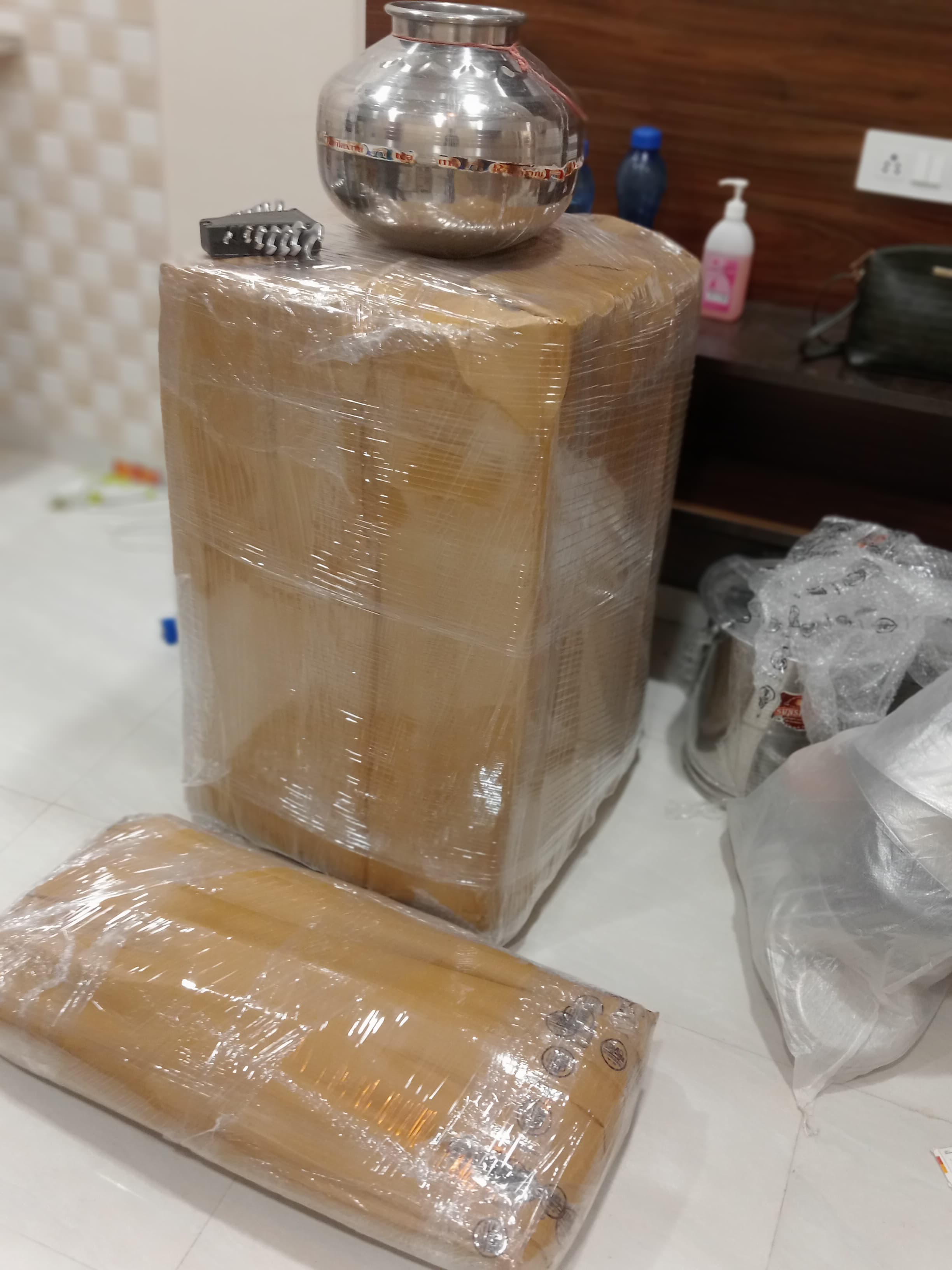 Movers wrapping a TV with protective padding