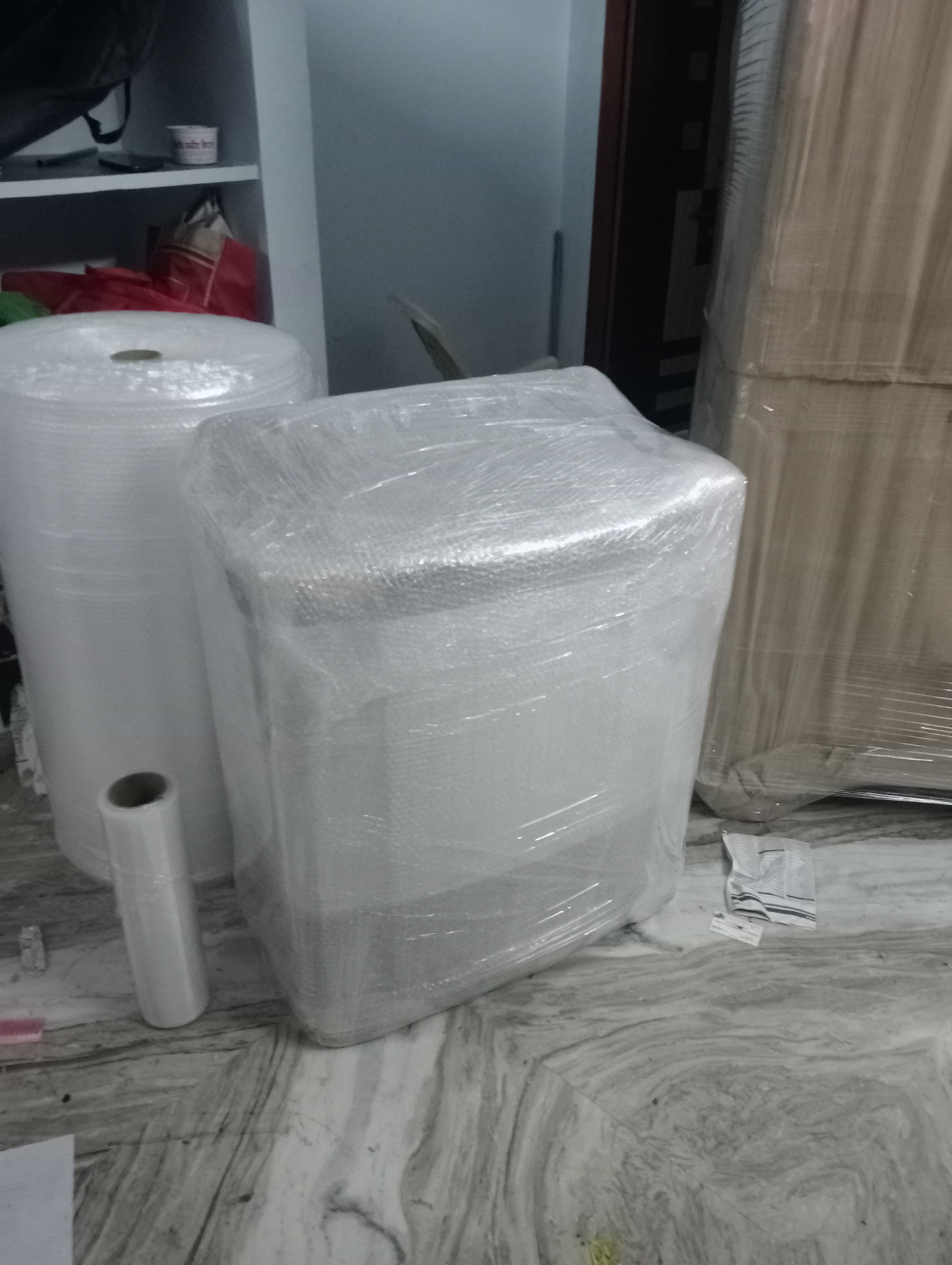 Movers loading gym equipment into the truck